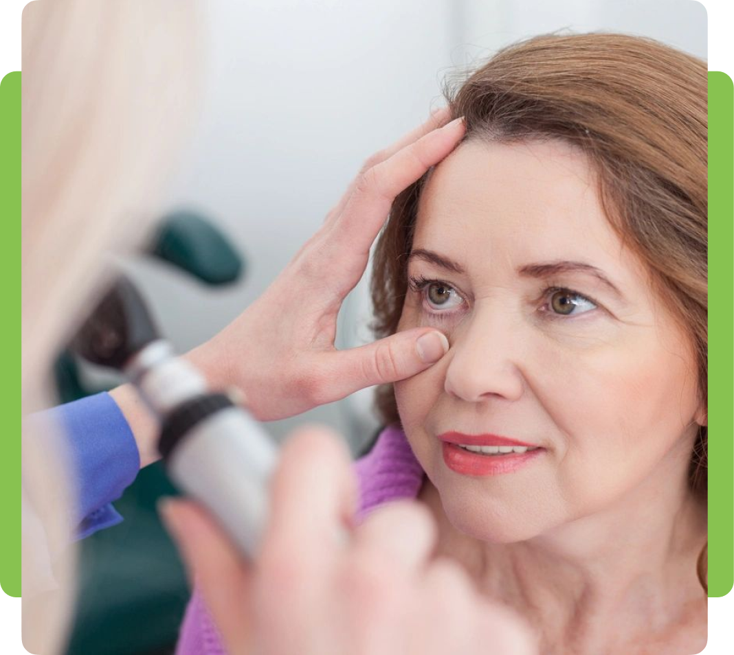 A woman getting her eye examined by an ophthalmologist.